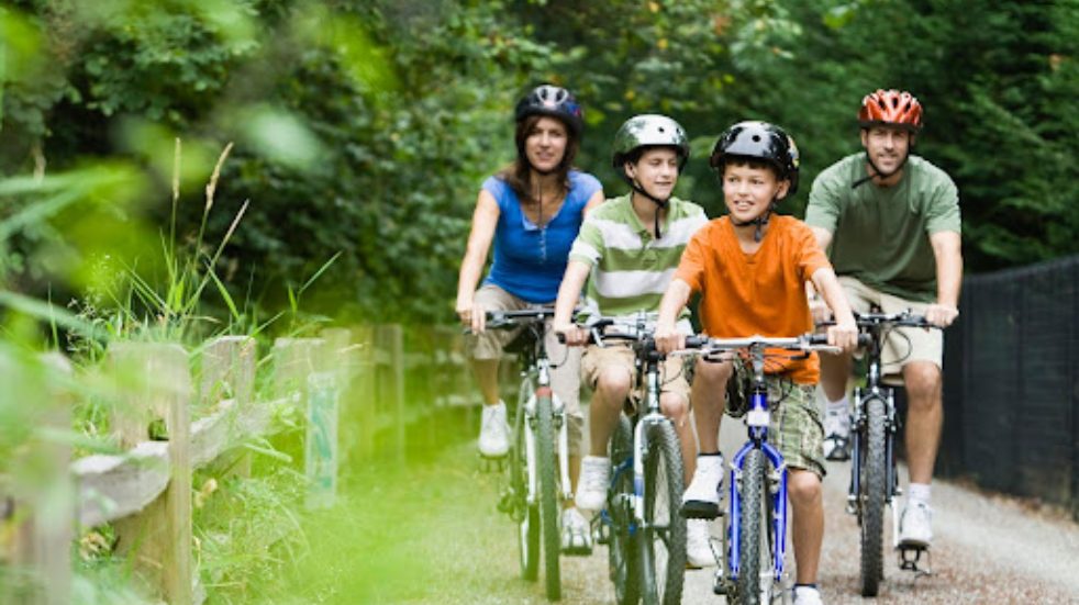 Family cycling on trail